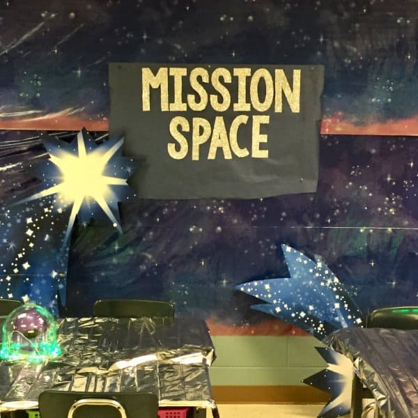 Teaching About Space: A starry backdrop with shooting stars, and Mission Space in glittering text on black paper.