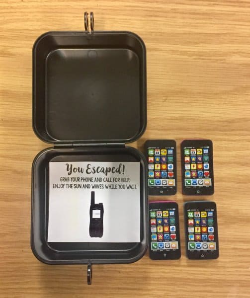 Escape Room container with toy mobile phones on a desk