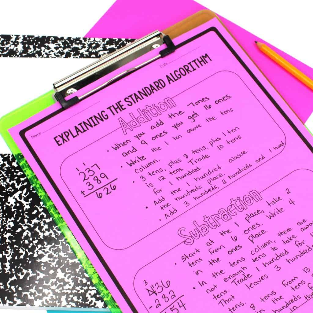 Addition and subtraction standard algorithm worksheet on neon pink paper on clipboard